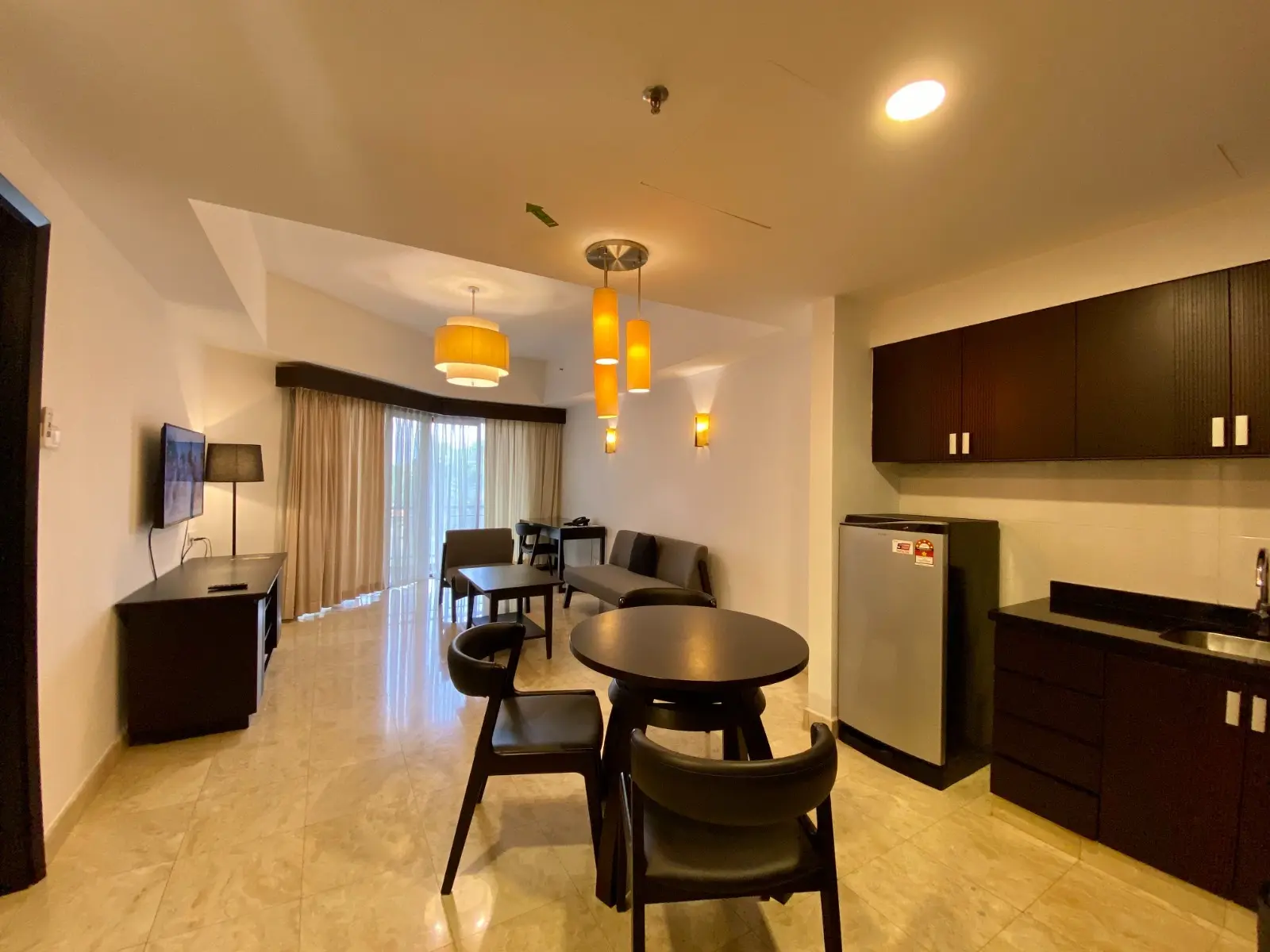 Living and dining area of a 1-bedroom suite with kitchenette