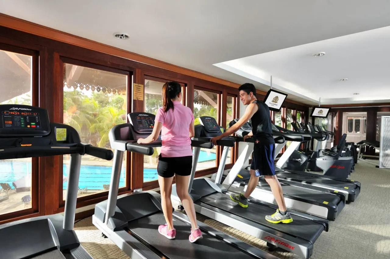 Resort gym with treadmills overlooking the pool